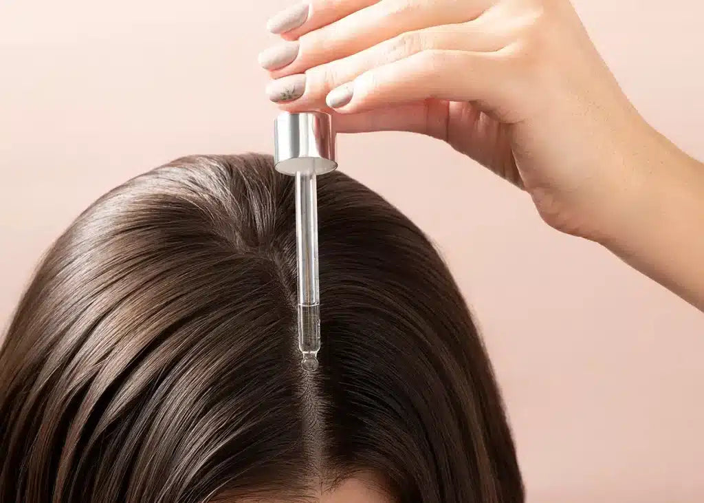 Woman examining thinning hair at her parting